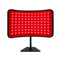 Katalyst 2-in-1 red light therapy lamp — curved desktop LED panel on adjustable black stand, white background product shot.